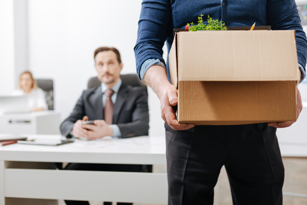 Confident employee leaving the office with his personal stuff