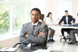 Lonely African-American businessman in office. Stop racism